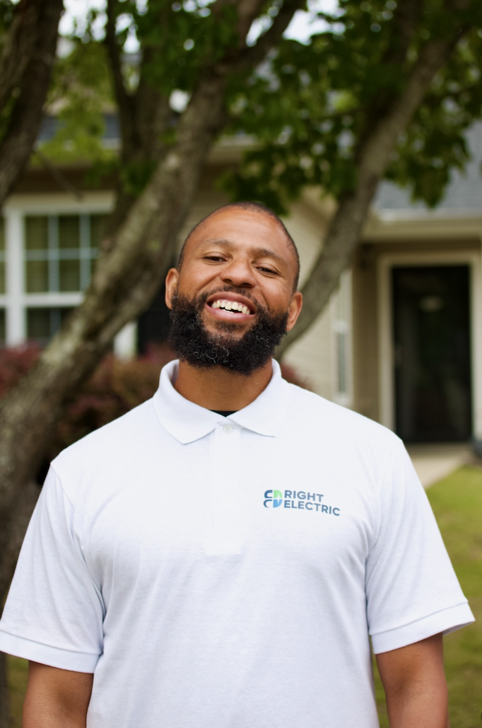 Christopher, founder of Right Electric, in a Right Electric polo outside his home in Charlotte, NC